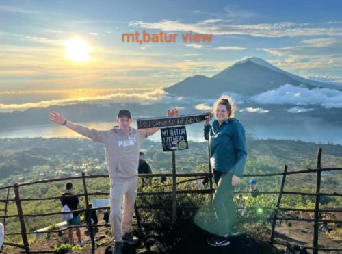 a man and a woman standing on top of a mountain at Bali Cottages Lake View in Kintamani