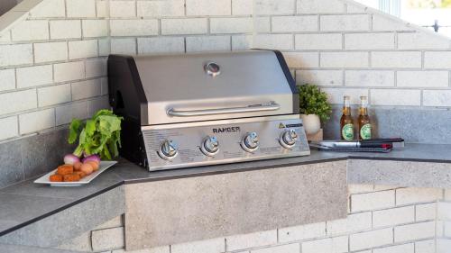 a grill sitting on a counter with fruits and vegetables at Anchorage in Greenwell Point