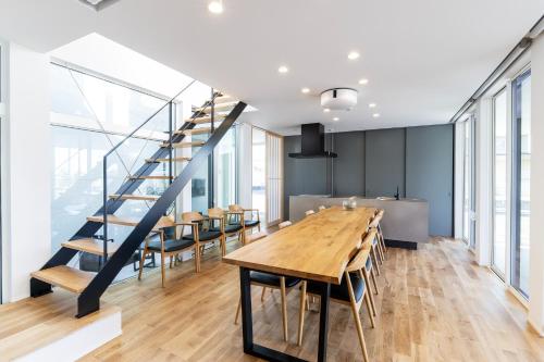 a dining room with a table and chairs and a staircase at nabe cape - Vacation STAY 04217v in Tagawa