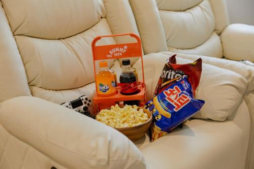 a white couch with snacks and a bowl of popcorn at Cheonan Aank Hotel Seongjeong in Cheonan