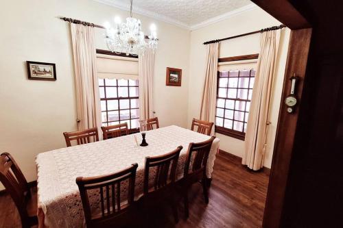 a dining room with a white table and chairs at Historic Schoolhouse Rockley in Rockley