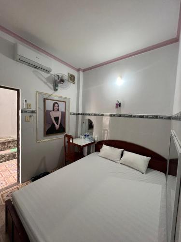 a bedroom with a large white bed in a room at Mai Phương Thúy Motel in Bien Hoa