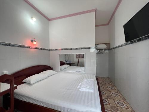 a bedroom with two beds and a flat screen tv at Mai Phương Thúy Motel in Bien Hoa