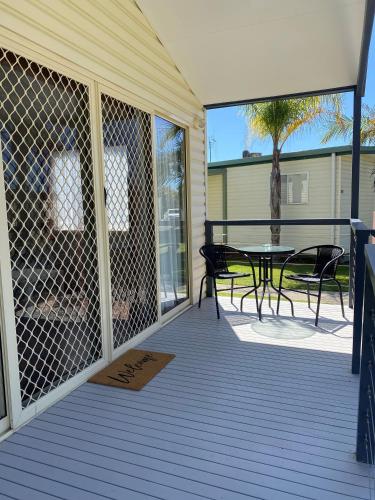 a screened in porch with a table and chairs at BIG4 Moama Holiday Park in Moama
