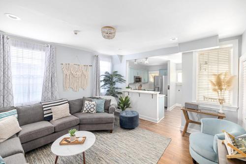 a living room with a couch and a table at Stunning Private Courtyard - 1 BLOCK TO KING in Charleston