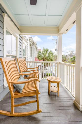 a porch with two rocking chairs and a table at Private Balcony 2 Living Rooms 2 Blocks to King in Charleston