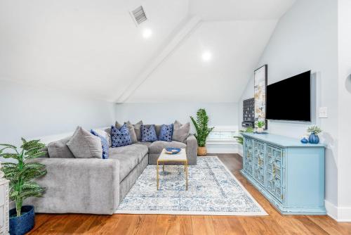 a living room with a couch and a tv at Private Balcony 2 Living Rooms 2 Blocks to King in Charleston