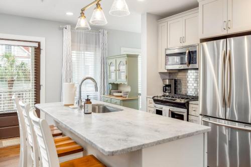 a kitchen with white cabinets and a large kitchen island at Private Balcony 2 Living Rooms 2 Blocks to King in Charleston