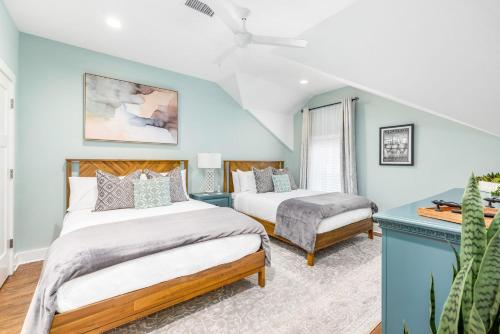 a bedroom with two beds and a blue wall at Private Balcony 2 Living Rooms 2 Blocks to King in Charleston