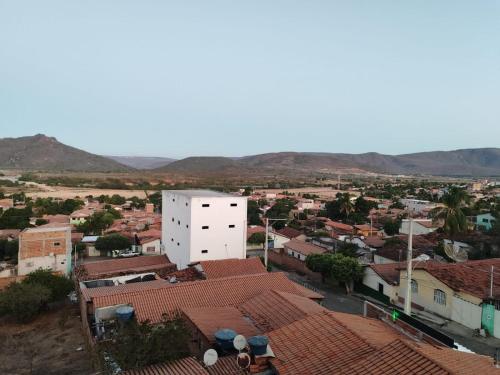 an aerial view of a city with buildings and mountains at Pousada Gomes in Itaobim