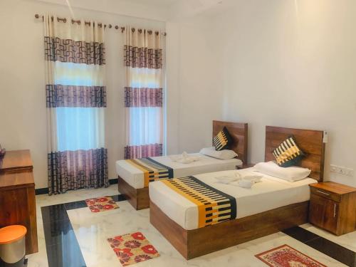 A bed or beds in a room at Yala River Front Hotel & Restaurant