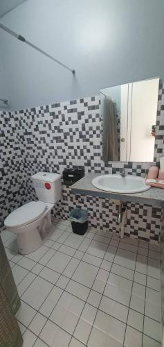 a bathroom with a toilet and a sink at Khao Sok 99 Camp and Cafe in Khao Sok National Park