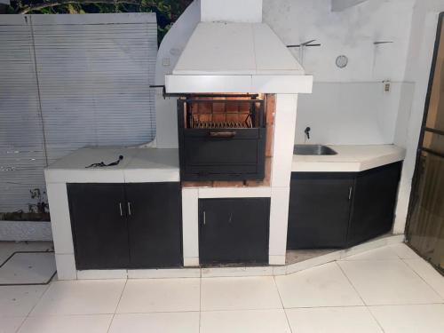 a small kitchen with a stove and a sink at Country village San Bernardino in San Bernardino