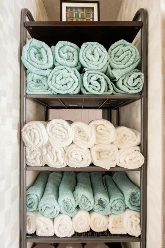 a bunch of rolled towels on a shelf at 201 Ueno TOKYO Secret house in Tokyo