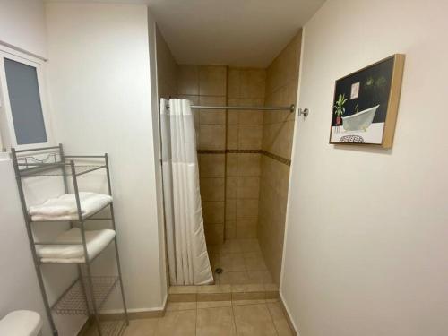 a bathroom with a shower with a shower curtain at Hermoso Departamento frente al Mar in Tijuana