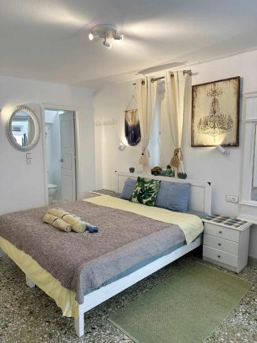 a bedroom with a bed with a teddy bear on it at Terra Nova in Mikonos