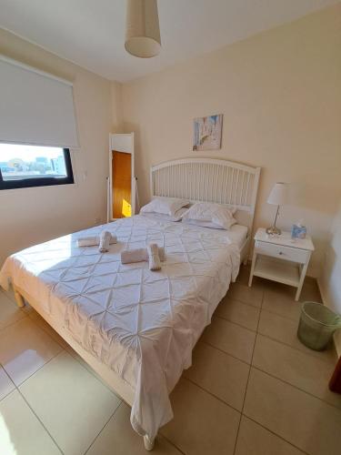 a bedroom with a large bed with towels on it at Albert's apartment Centre 601 in Larnaca