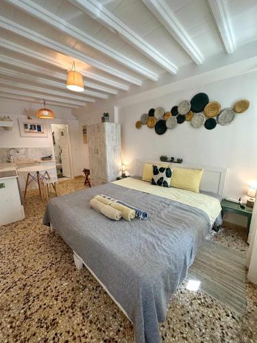 a bedroom with a large bed with plates on the wall at Petra Pelikan in Mikonos