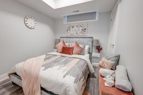 1 dormitorio con 1 cama y reloj en la pared en Cozy Nest, en Niagara Falls