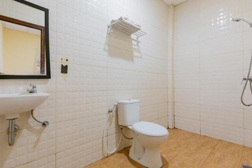 a bathroom with a toilet and a sink at RedDoorz @ Iodium Residence Cikarang in Jakarta