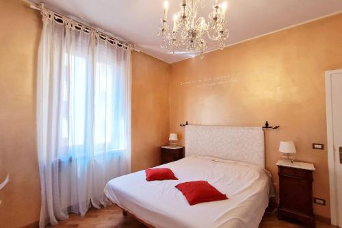 a bedroom with a bed with two red pillows on it at Luxury Verona Apartment City Centre in Verona