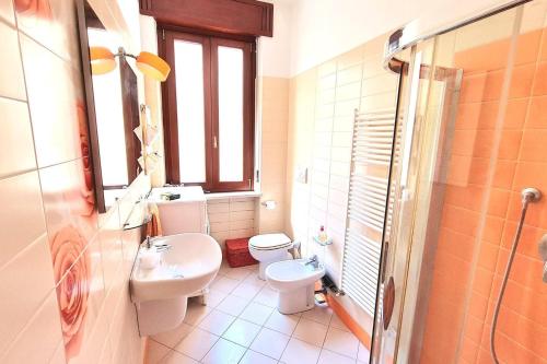 a bathroom with a white toilet and a sink at Luxury Verona Apartment City Centre in Verona