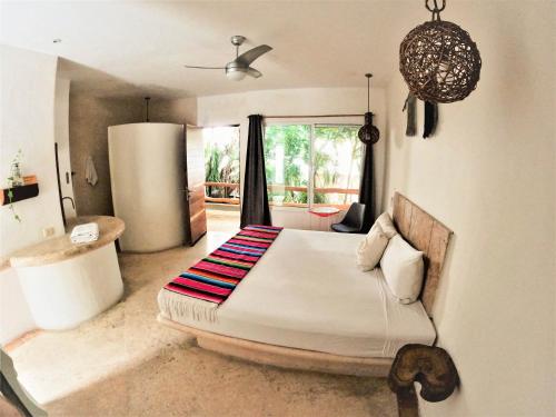 a bedroom with a large bed in a room at Rustik-inn Rooms in Playa del Carmen