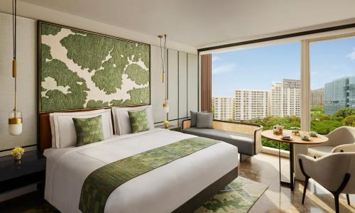 a bedroom with a large bed and a large window at Taj The Trees, Mumbai in Mumbai