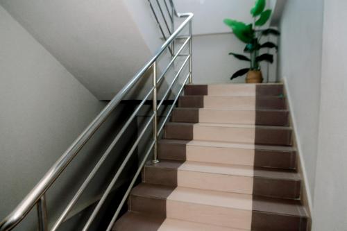 a staircase with metal railings and a potted plant at HOTEL D VIEW MERSING in Mersing