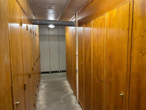 a row of wooden lockers in a room at Alpe d Huez 6 pers appart in LʼHuez