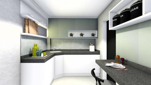 a kitchen with a counter with a sink and a counter at Barão da torre in Campos dos Goytacazes
