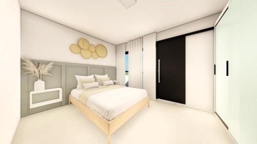 a white bedroom with a bed and a window at Barão da torre in Campos dos Goytacazes