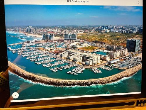 a picture of a marina with boats in the water at Luxury apartment on the beach in Herzelia 