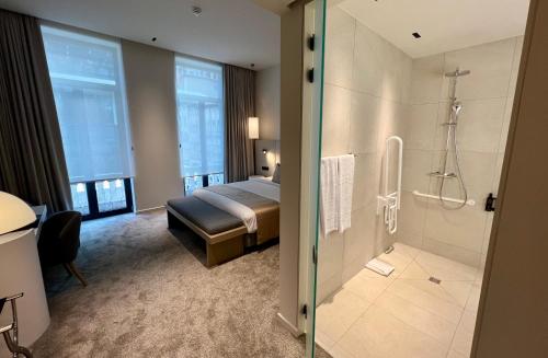 a hotel room with a bed and a shower at OPO Hotel in Brussels