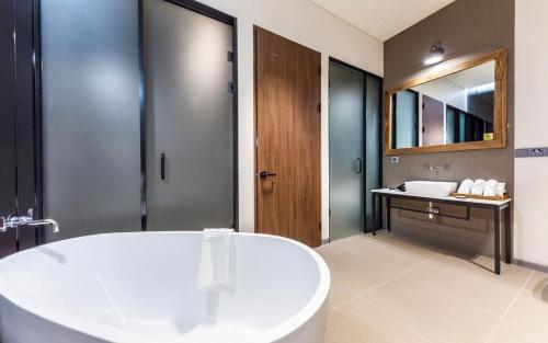 a bathroom with a large tub and a sink at Hotel The Artist Yeonsinnae in Seoul