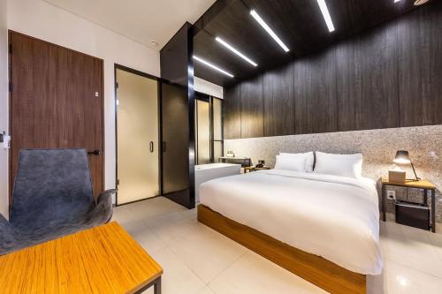 a bedroom with a large bed and a bathroom at Hotel The Artist Yeonsinnae in Seoul