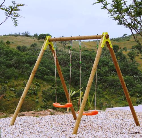 an empty swing set with two swings at Casas de Campo do Castro da Cola in Marchicão