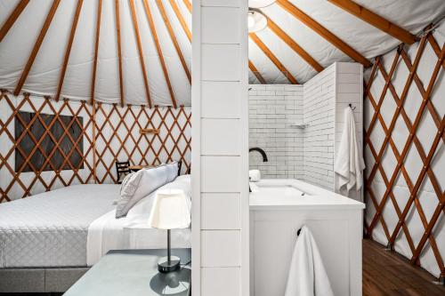 a bathroom with a bed and a sink in a yurt at OT 3515B Texas Yurt Haus Buffalo in New Braunfels