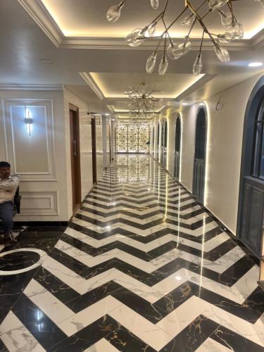 a lobby with a black and white checkered floor at RESIDE INN AVENUE in Bengaluru