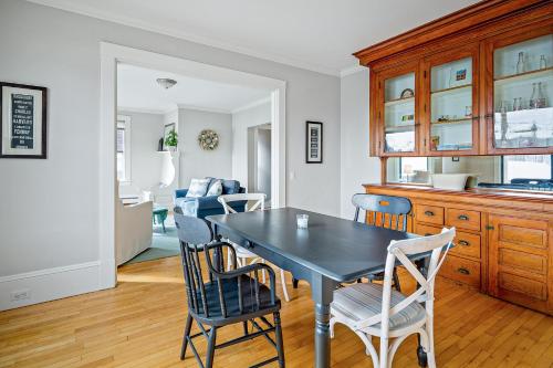 a dining room with a black table and chairs at Harborwalk Upper in Camden