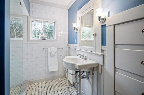 a white bathroom with a sink and a mirror at Harborwalk Upper in Camden