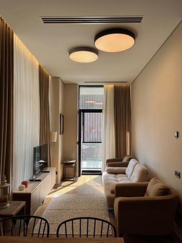 a living room with two couches and a television at Sea Breeze Lighthouse hotel in Nardaran