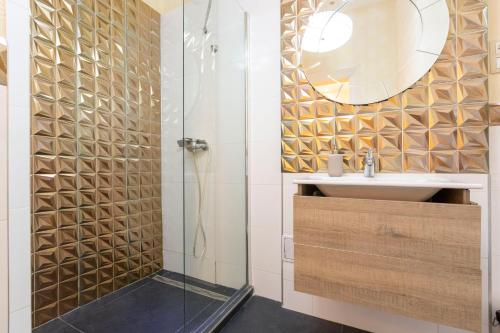 a bathroom with a shower with a sink and a mirror at Deluxe Izabella Apartment in the Center of Budapest in Budapest