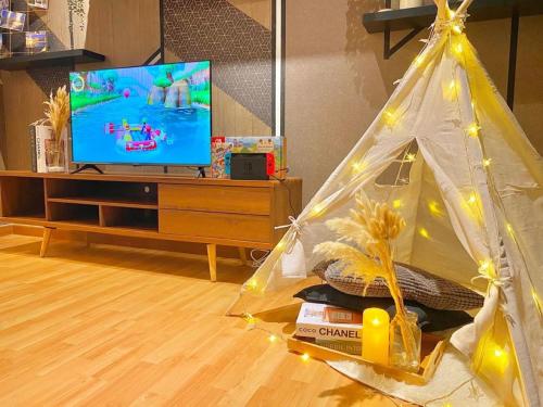 a living room with a tv and a tent at imperium residence kuantan in Kuantan