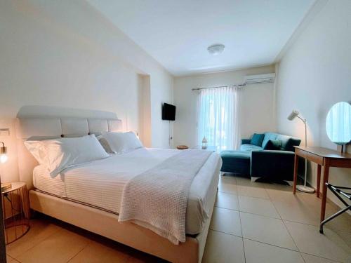 a bedroom with a large bed and a couch at Annamaria Sea Side View Studio- 25m From The Beac in Plakias