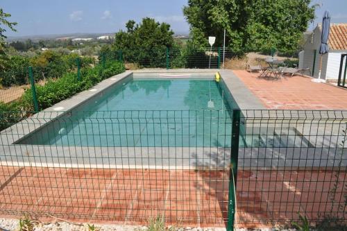 a swimming pool with a net in a backyard at Casa rural La Liñana in Córdoba