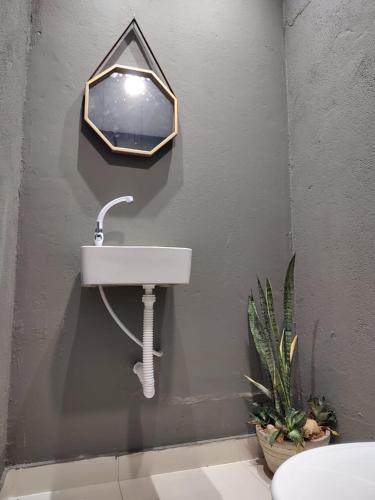 a bathroom with a sink and a mirror on the wall at Casa Frida 1 in Natal