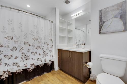 a bathroom with a shower curtain and a toilet at Apart Hotel at Chinatown in Los Angeles