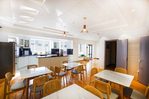 a kitchen and dining room with tables and chairs at White hostel Mongolia in Ulaanbaatar