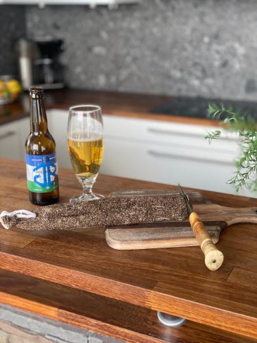 a bottle of beer next to a glass and a knife at Ottsjö-Åre Lodge in Ottsjö